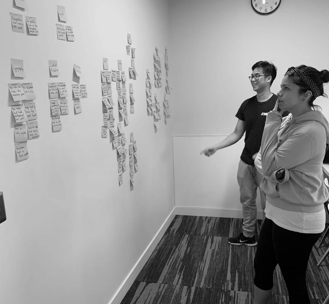 Team affinity mapping with sticky notes on wall
